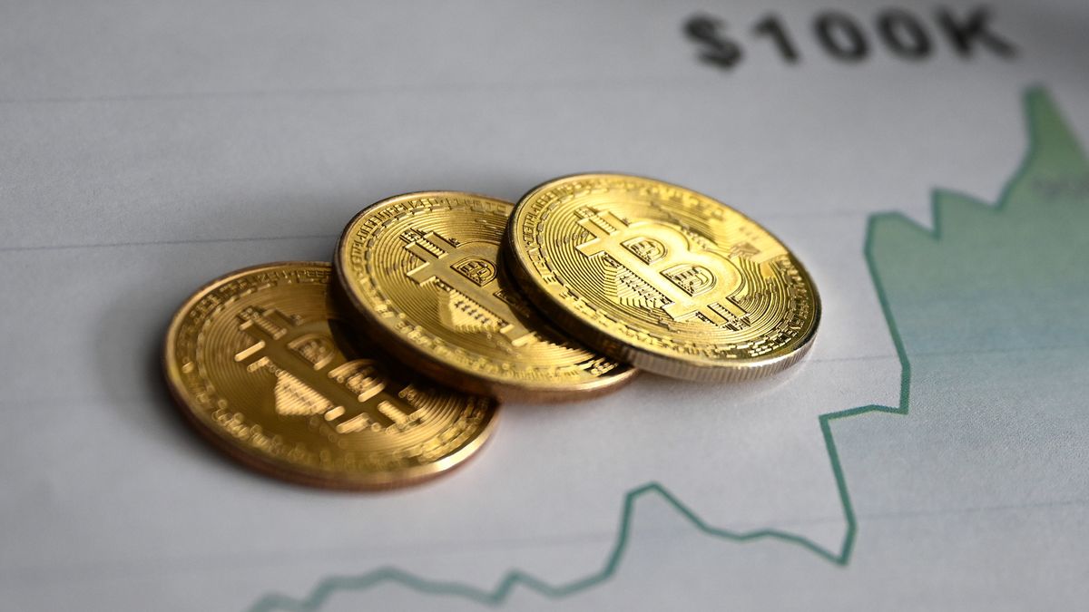 ANKARA, TURKIYE - NOVEMBER 23: In this photo illustration, 'Bitcoin' coins are displayed on a graphic chart showing an upward trend, with the label '$100K,' in Ankara, Turkiye on November 23, 2024. (Photo by Hakan Nural/Anadolu via Getty Images)