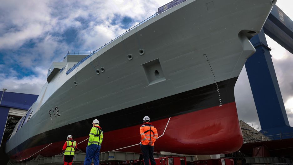 ROSYTH, SCOTLAND - MAY 27: Type 31 frigate HMS Venturer is rolled out from the build hall at Babcock Rosyth on May 27, 2025 in Rosyth, Scotland. The Royal Navy's new frigate, the HMS Venturer, is the first of the Inspiration Class Type 31 frigates built by Babcock International in Rosyth. HMS Venturer will be capable of deployment for a variety of roles, including defence, maritime security, counter-piracy, and disaster relief missions, and is fitted out with the largest flight deck any Royal Navy frigate or destroyer. (Photo by Jeff J Mitchell/Getty Images)
