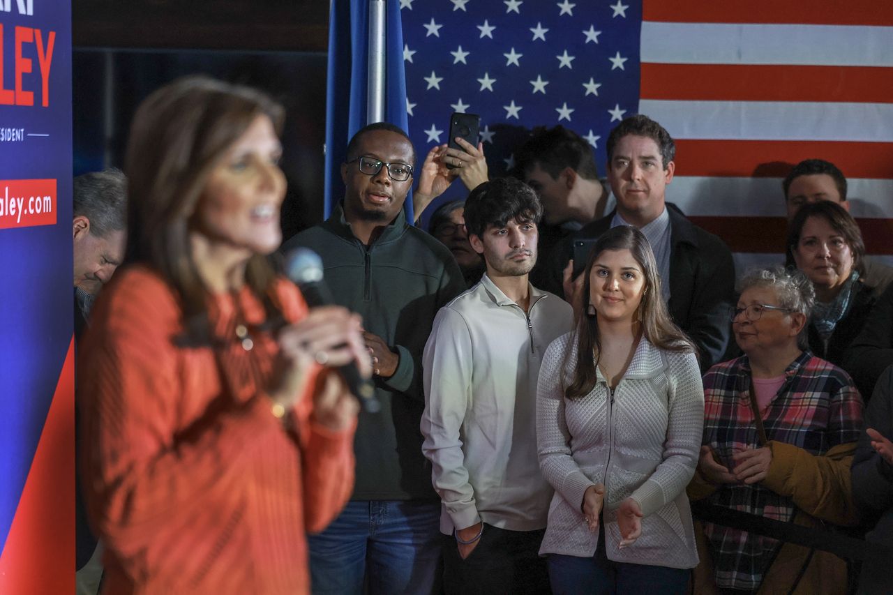 FRANKLIN, NEW HAMPSHIRE - JANUARY 22: Rena Haley (R) and her husband Joshua (L) along with Nalin Haley (C) watch as their mother Republican presidential candidate, former U.N. Ambassador Nikki Haley, speaks during a campaign event at the Franklin VFW on January 22, 2024, in Franklin, New Hampshire. Haley continues to campaign across New Hampshire ahead of the state's January 23 primary.  (Photo by Joe Raedle/Getty Images)