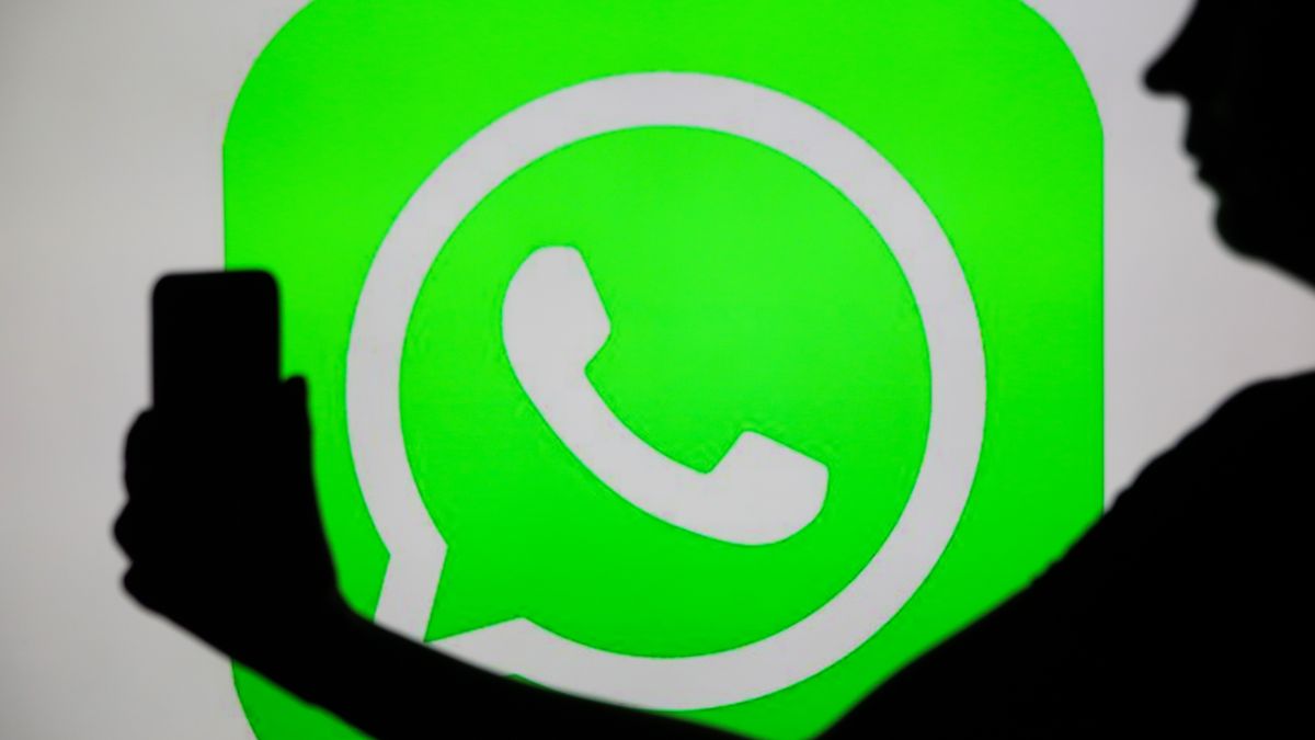 The WhatsApp logo with a person holding a phone in their hand is seen in Knurow, Poland, on December 26, 2024. (Photo by Klaudia Radecka/NurPhoto via Getty Images)