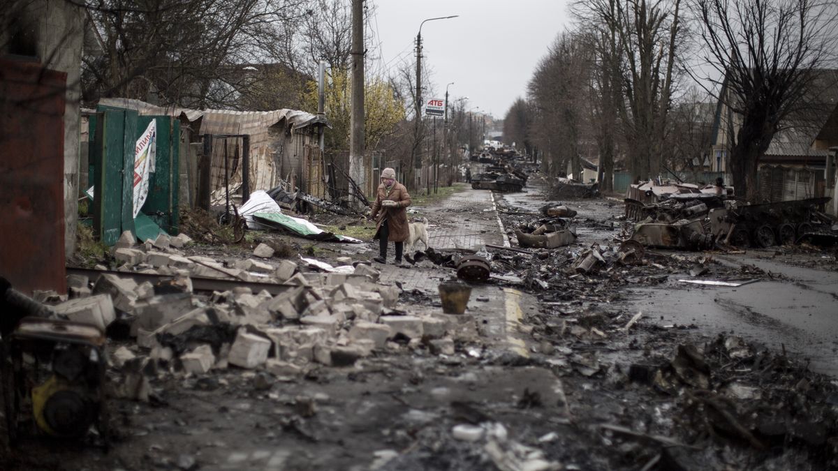 BUCHA, KYIV PROVINCE, UKRAINE, APRIL 08: An elder woman walks amid destruction on a street in the town of Bucha, on the outskirts of Kyiv, after the Ukrainian army secured the area following the withdrawal of the Russian army from the Kyiv region on previous days, Bucha, Ukraine, April 8th, 2022. (Photo by Narciso Contreras/Anadolu Agency via Getty Images)