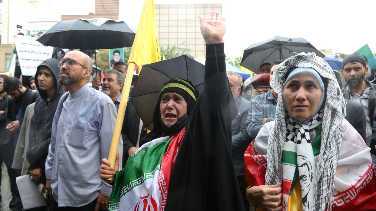 TEHRAN, IRAN - SEPTEMBER 28: An Iranian woman mourn as thousands of people gather in Felestin Square, despite the rain, to protest the Israeli attacks in Lebanon that killed Hezbollah leader Hassan Nasrallah and Iranian Brigadier Gen. Abbas Nilforoushan in Tehran, Iran on September 28, 2024. Demonstrators carrying Lebanese and Palestinian flags and posters of Nasrallah chanted slogans against Israel and the US. (Photo by Fatemeh Bahrami/Anadolu via Getty Images)