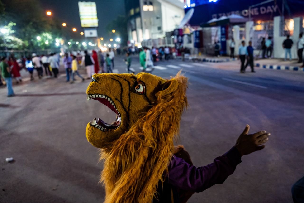 KOLKATA, WEST BENGAL, INDIA - 2023/10/27: A Chhau dancer (semi classical Indian dance with martial and folk traditions) passes through a road while wearing a mask of lion as he takes part during the Durga Puja carnival. Durga Puja is a Hindu festival and one of the biggest Bengali festivals, included in UNESCO's Intangible Cultural Heritage of Humanity. Durga Puja represents the collective worship of the Hindu Goddess Durga. The West Bengal Government organized a carnival with various puja pandals in Kolkata, India. Clubs participate in this carnival by arranging tableaus, dancing, and singing. (Photo by Jit Chattopadhyay/SOPA Images/LightRocket via Getty Images)