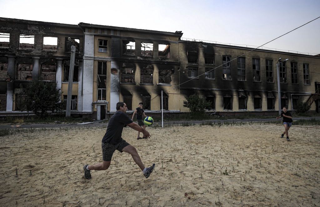 Russian attacks on UkraineKHARKIV, UKRAINE - JUNE 10: Roman Tetelocko (40), a resident of Kharkiv is seen playing a volleyball with his daughter and her two friends at the sports field located in the playground of the school building number 134, as Russian attacks on Ukraine continue on June 10, 2022 in Kharkiv, Ukraine. In Kharkiv, citizens are trying to survive, despite the shelling that continues at night. In the city, where many points in the city center have fallen into ruins after the attacks, some Ukrainians, who come to the sports grounds in the playground of the school building number 134, play volleyball with their children. (Photo by Metin Aktas/Anadolu Agency via Getty Images)Anadolu Agencyrussian attacks