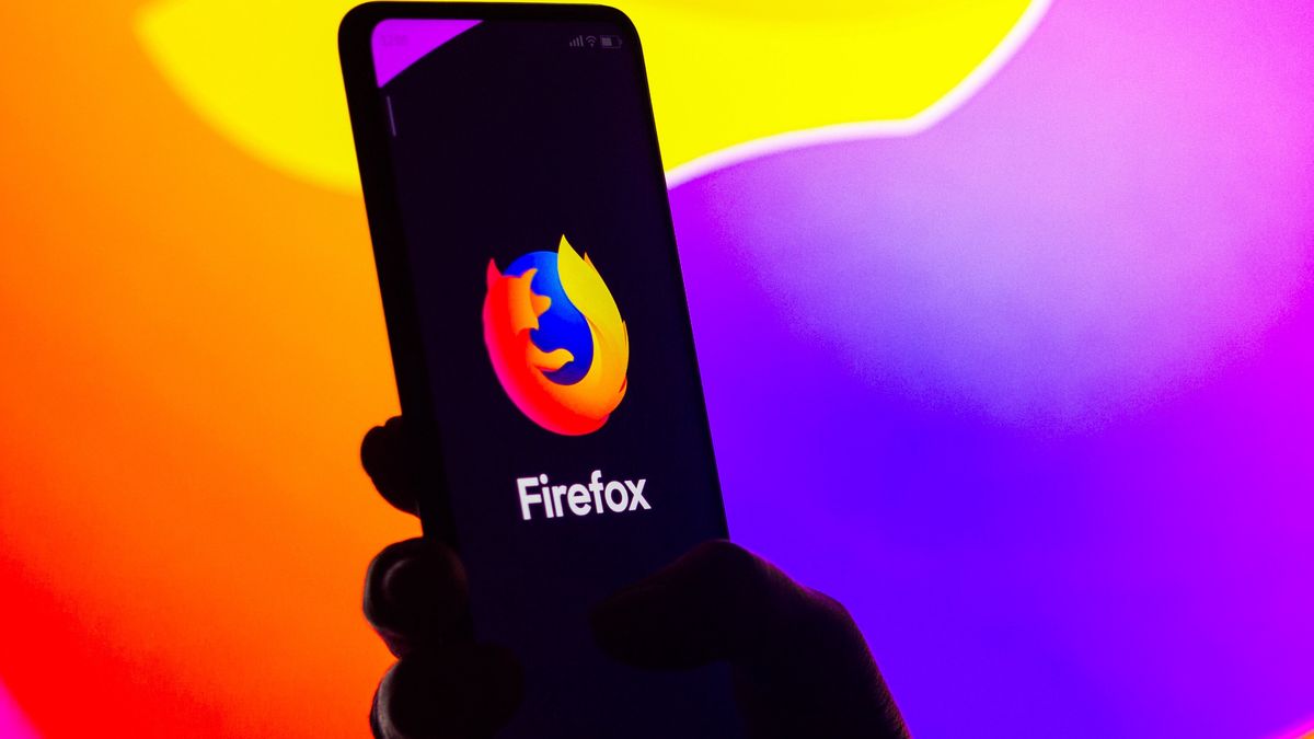 BRAZIL - 2022/04/27: In this photo illustration, a silhouetted woman holds a smartphone with the Mozilla Firefox logo displayed on the screen. (Photo Illustration by Rafael Henrique/SOPA Images/LightRocket via Getty Images)