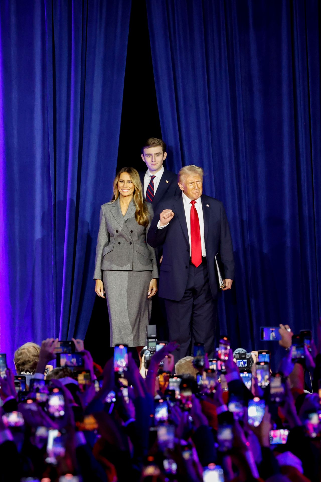 Former US First Lady Melania Trump, from left, former US President Donald Trump, and their son Barron Trump during an election night event at the Palm Beach Convention Center in West Palm Beach, Florida, US, on Wednesday, Nov. 6, 2024. Trump is on the cusp of recapturing the White House, projected as the winner across pivotal swing states with his party set to control the Senate and markets swinging in expectation of his possible victory. Photographer: Eva Marie Uzcategui/Bloomberg via Getty Images