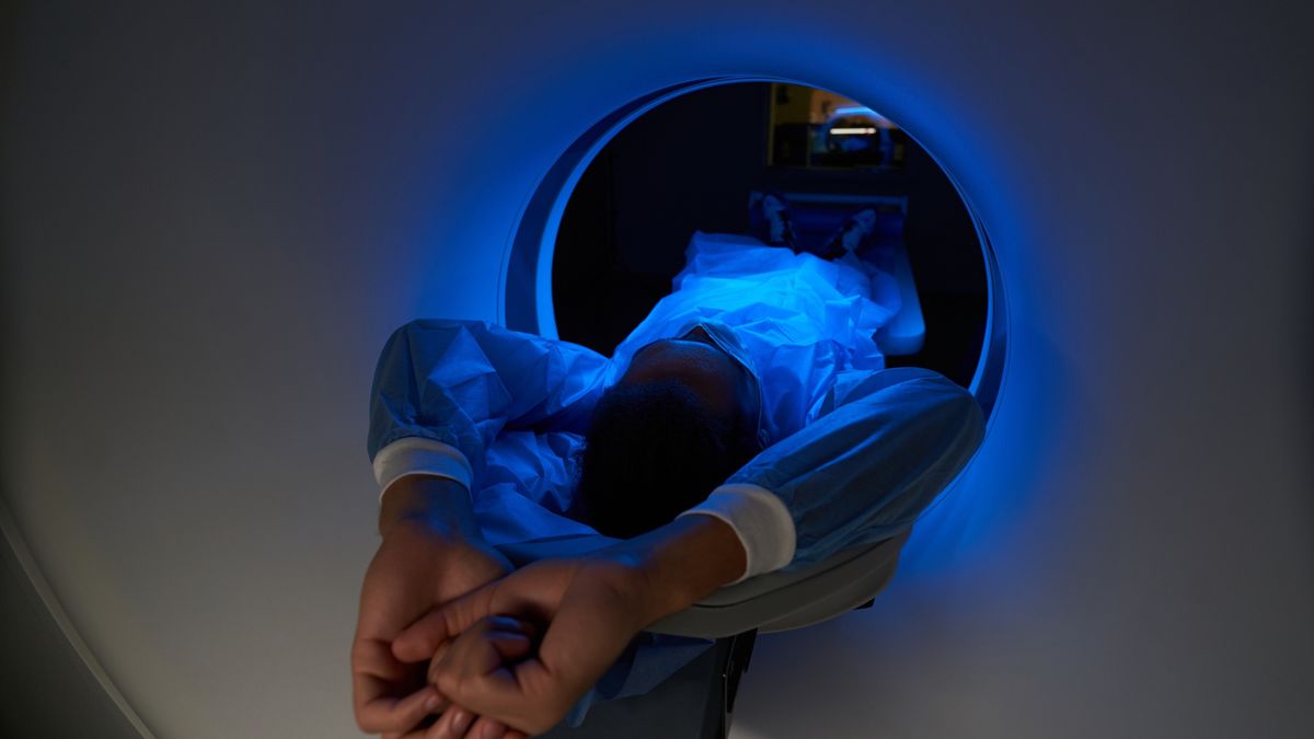 Young man during diadnostic in MRI scannerClose up of male patient lying inside cylindric machine while being examined in modern clinicSvitlana Hulko