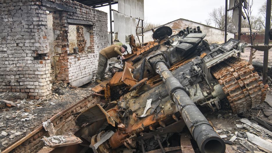 A man looks at russian T-72 tank destroyed during Russia's invasion to Uktaine, Ivanivka village, Chernihiv area, Ukraine, 20 April 2022 (Photo by Maxym Marusenko/NurPhoto via Getty Images)
