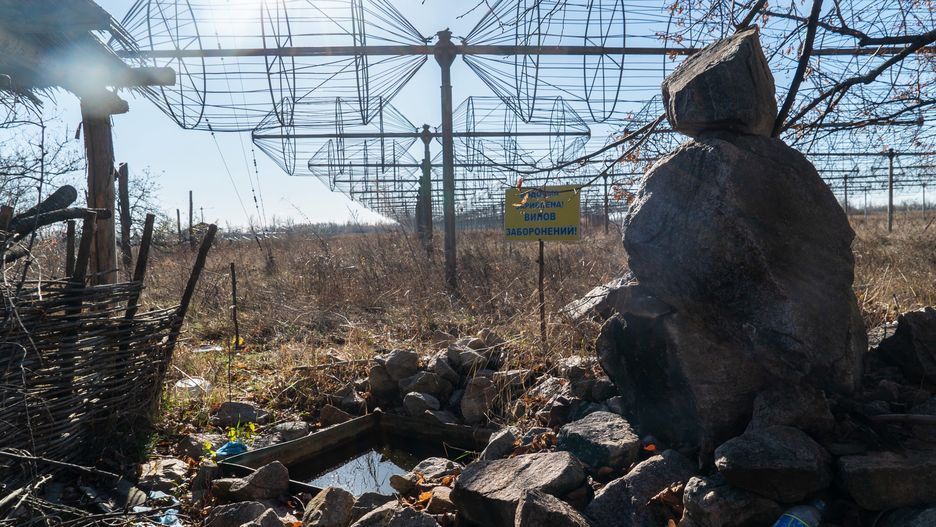 KHARKIV OBLAST, UKRAINE - NOVEMBER 16: Rubble lies in front of a phased array antenna of a radio telescope damaged by Russian military on November 16, 2023 in Kharkiv Oblast, Ukraine. The building of the radio astronomy observatory damaged by shelling is located near Volokhiv Yar in Kharkiv Oblast. The world’s largest low-frequency radio telescope UTR-2 worked here, with the help of which Kharkiv scientists explored space for more than 50 years. Before the start of the full-scale Russian invasion 2022, scientists used the telescope to observe Jupiter from here, recorded lightning charges on Saturn, and had joint projects with astronomers from Japan and France. Russian soldiers lived here for more than six months of the Russian occupation. As a result of the fighting in Kharkiv Oblast, the observatory building, and the telescope were damaged. A year after the liberation of the territory from the Russian military, roads and sidewalks were cleared of mines, the roof of the central building was covered with film. In general, several tens of millions of euros are needed to restore the complex. (Photo by Oleksandr Stavytskyy/Suspilne Ukraine/JSC "UA:PBC"/Global Images Ukraine via Getty Images)