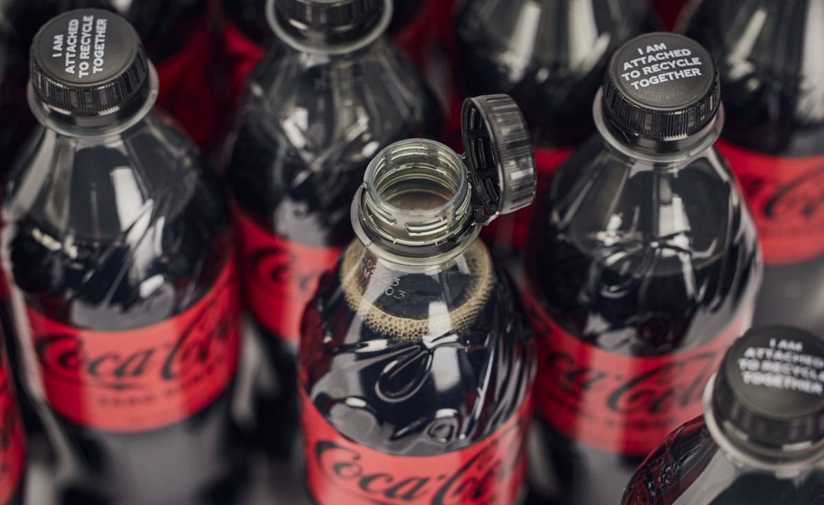 Coca-Cola bottles with the label "I am attached to recycle together"