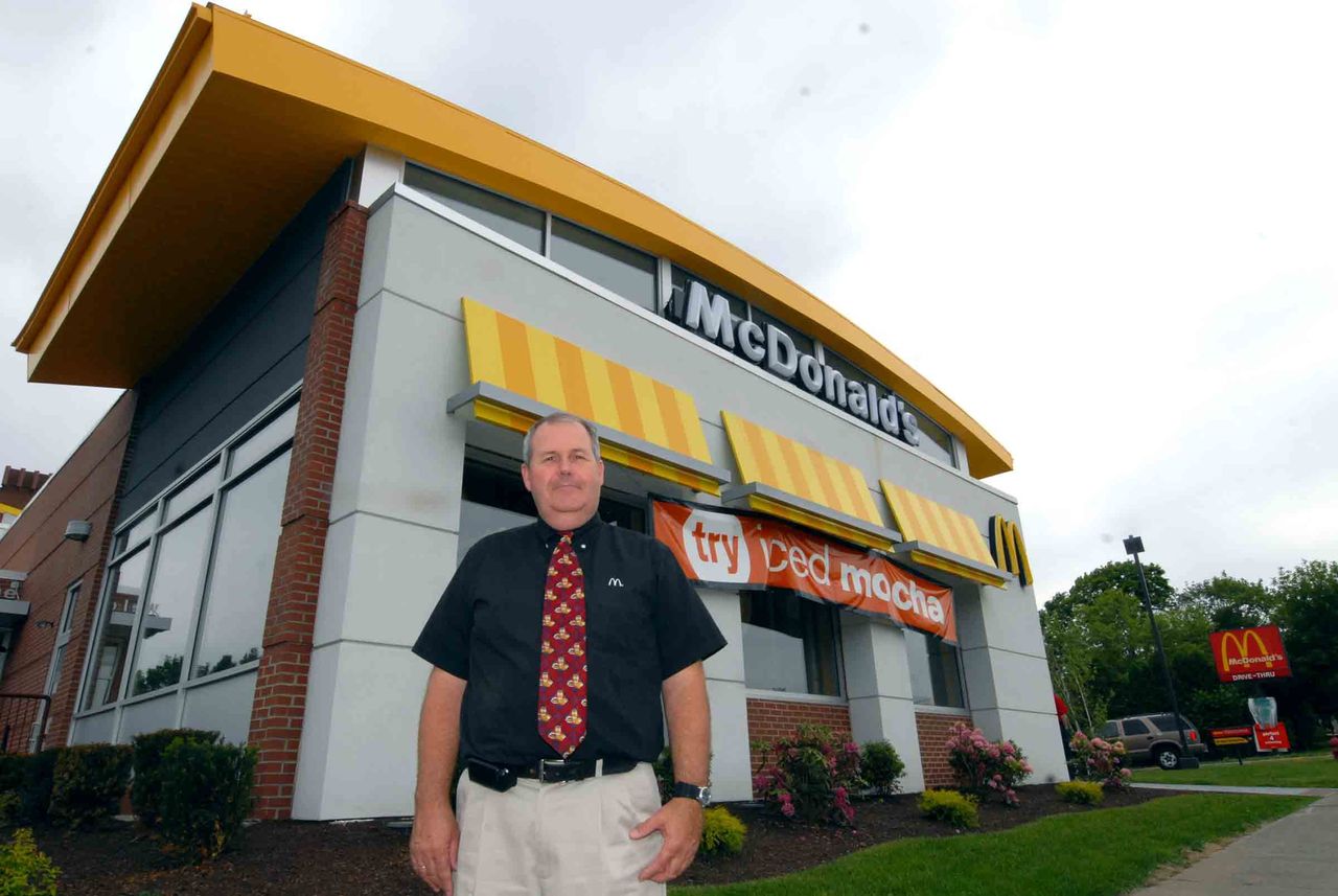 Co-owner /operator with his wife Pat , Douglass Arnott (cq) in front of  their recently redesigned McDonalds in Watervliet , New York 06/03/2009. ( Michael P. Farrell / Times Union ) (Photo by Michael P. Farrell/Albany Times Union via Getty Images)