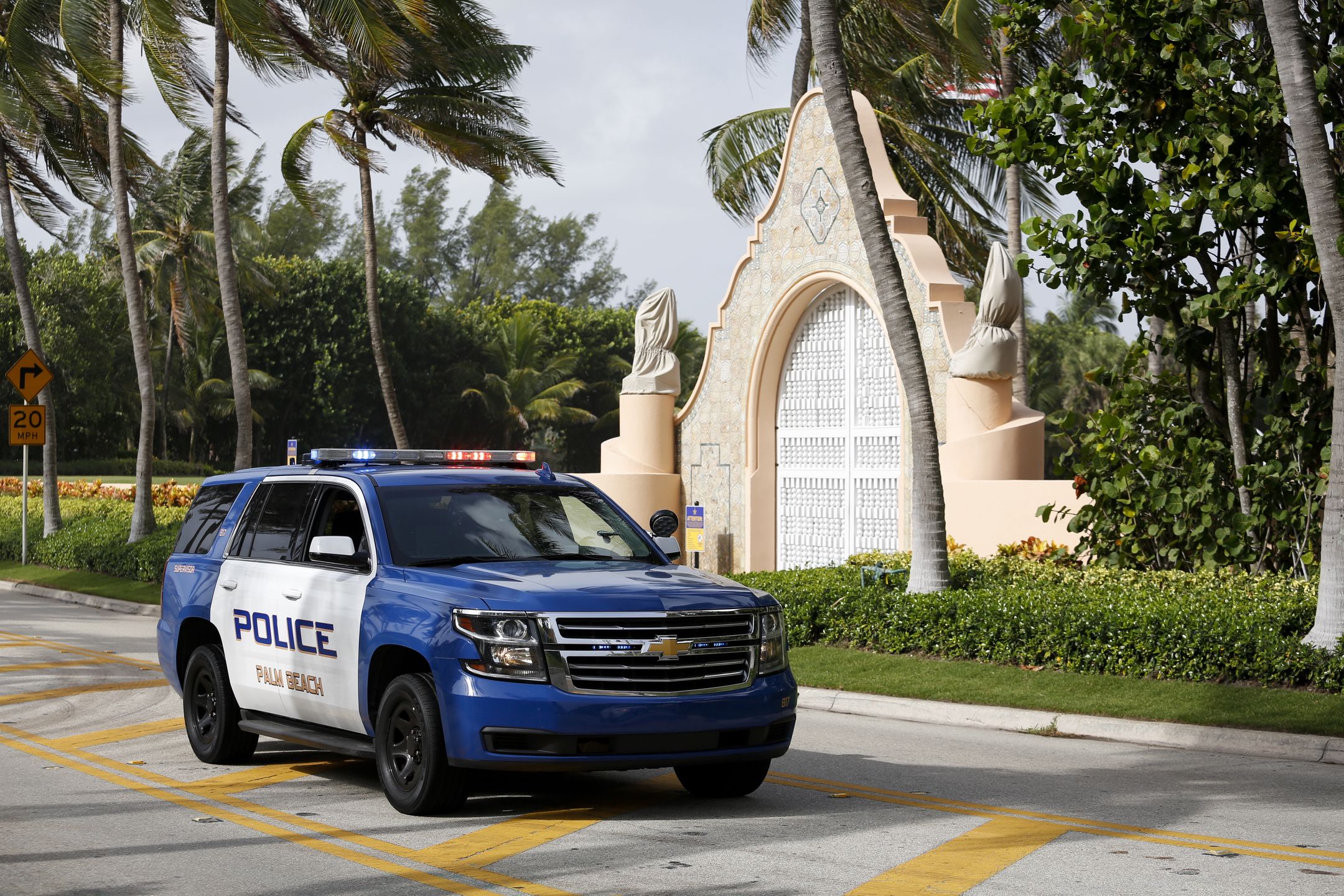 A Palm Beach Police officer at the entrance of former US President Donald Trump's house at Mar-A-Lago in Palm Beach, Florida, US, on Tuesday, Aug. 9, 2022. Donald Trump faces intensifying legal and political pressure after FBI agents searched his Florida home in a probe of whether he took classified documents from the White House when he left office, casting a shadow on his possible run for the presidency in 2024. Photographer: Eva Marie Uzcategui/Bloomberg via Getty Images
