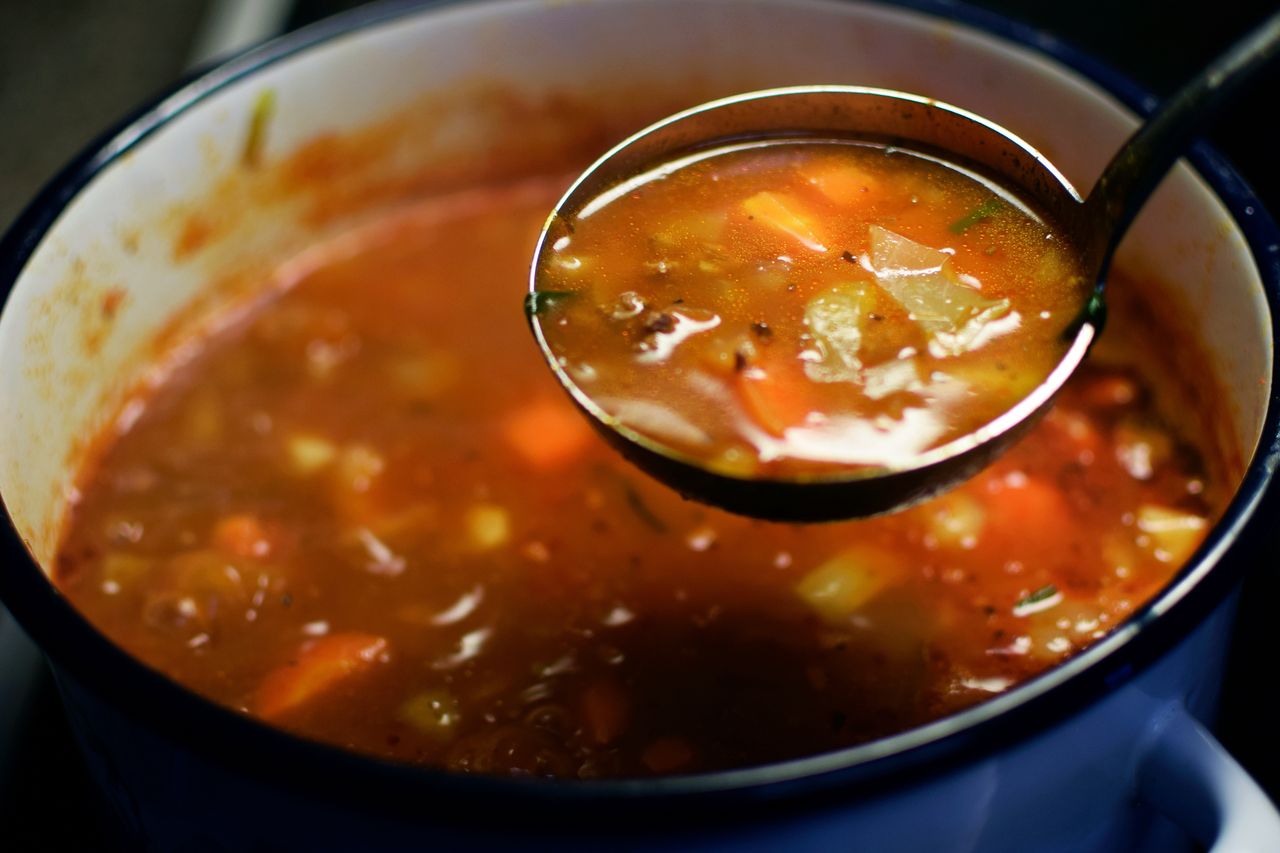 Delicious cabbage soup ladled out with a ladle