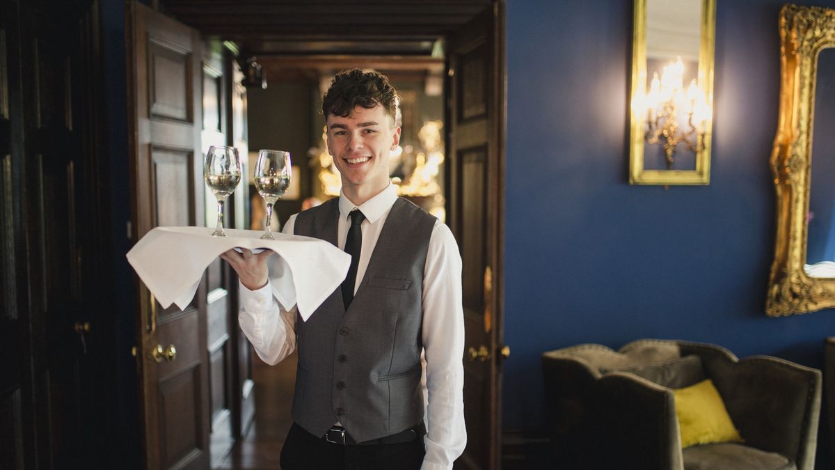 Service With a Smile
A well-dressed bartender is holding a tray with wineglasses to serve to guests.
SolStock
