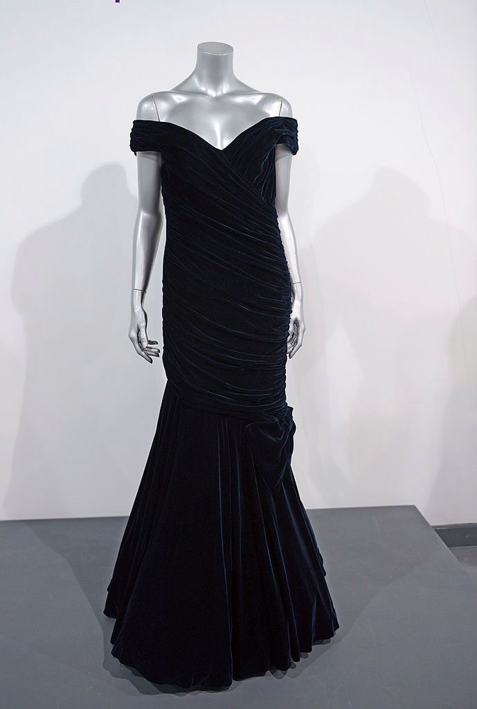 LONDON, UNITED KINGDOM - MARCH 15: A Victor Edelstein midnight-blue velvet evening gown worn to the state dinner at the white house given by the President and Mrs Reagan, when Princess Diana famously danced with John Travolta and 9th November 1985. Dresses are displayed at a photocall ahead of the the 'Fit For a Princess' auction.  10 dresses from the collection of Diana, Princess of Wales are to be auctioned by specialist Kerry Taylor on March 15, 2013 in London, England. (Photo by Karwai Tang/WireImage) 