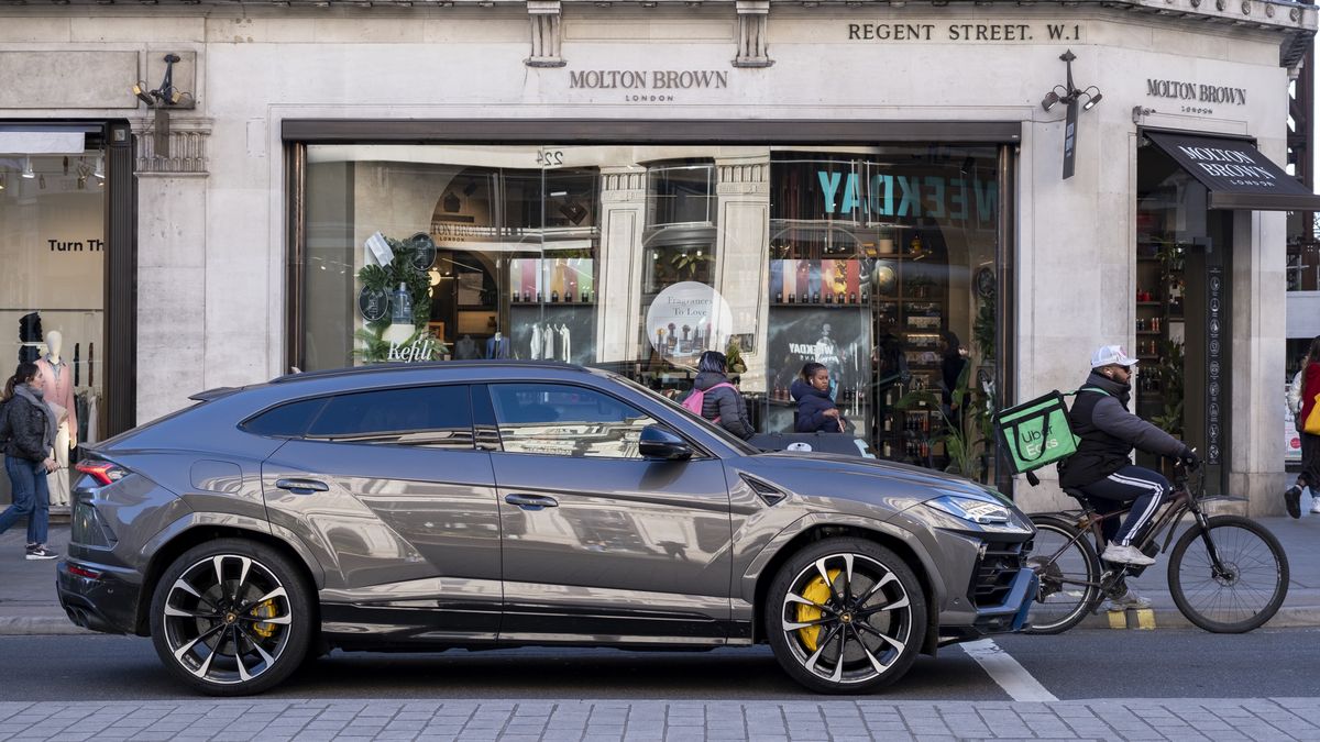 Lamborghini SUV car waits at the lights alongside a cycle delivery rider on Regent Street on 6th February 2023 in London, United Kingdom. Automobili Lamborghini is an Italian brand and manufacturer of luxury sports cars based in SantAgata Bolognese. The company is owned by the Volkswagen Group through its subsidiary Audi. (photo by Mike Kemp/In Pictures via Getty Images)