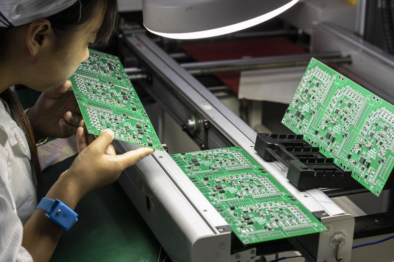 An employee inspects integrated circuit boards at the Smart Pioneer Electronics Co. factory in Suzhou, China, on Friday, Sept. 23, 2022. In a world where chips are becoming smarter and smaller, they require much less advanced technology to manufacture and therefore command smaller margins. Photographer: Qilai Shen/Bloomberg via Getty Images