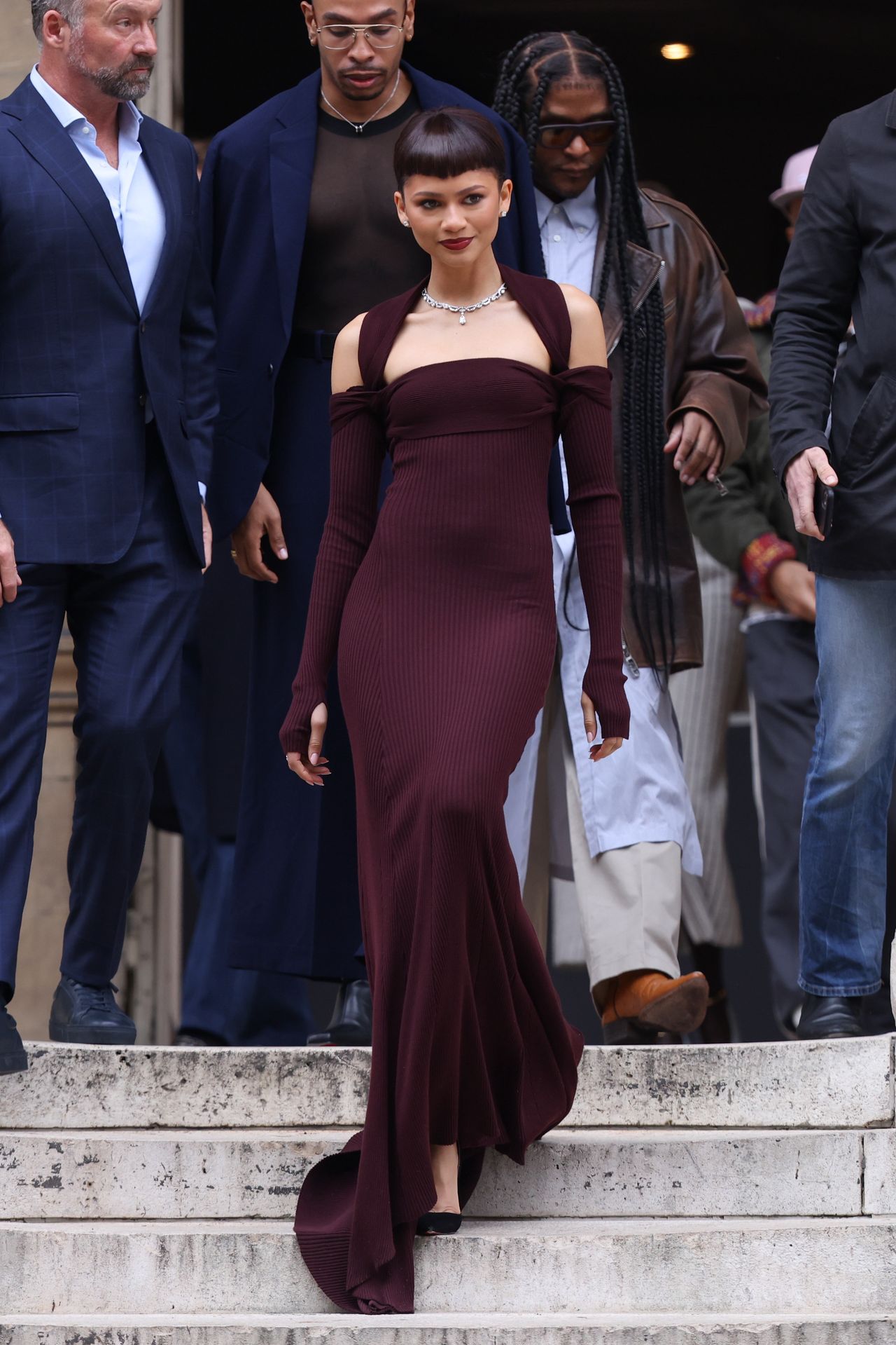 Zendaya in a burgundy dress at Fashion Week haute couture in Paris.
