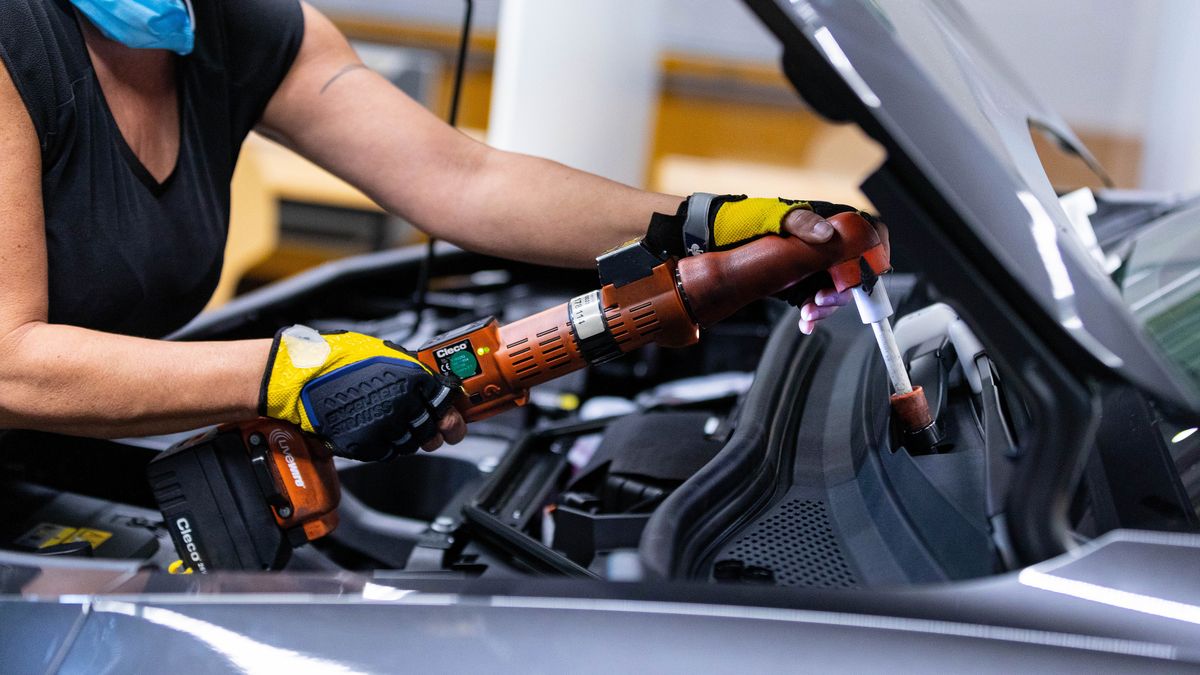 An employee fixes a fastener under the hood of a Volkswagen AG (VW) ID.5 electric sports utility vehicle (eSUV) on the assembly line at the automaker's electric automobile plant in Zwickau, Germany, on Tuesday, April 26, 2022. The Zwickau assembly lines are the centerpiece of a plan by VW, the world's biggest automaker, to manufacture as many as 330,000 cars annually. Photographer: Krisztian Bocsi/Bloomberg via Getty Images