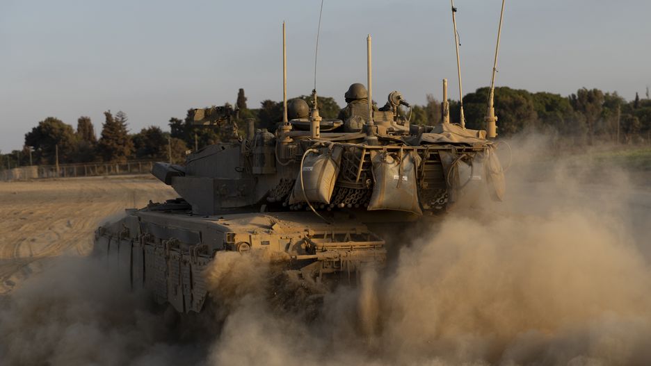 SOUTHERN ISRAEL, ISRAEL - AUGUST 7: Israeli soldiers in a tank as it drives along the border with the Gaza Strip on August 7, 2024 in Southern Israel, Israel. Ten months has passed since the Oct. 7th Hamas-led attack on southern Israel, which sparked a devastating war in Gaza that threatens to spill into the wider region. (Photo by Amir Levy/Getty Images)
