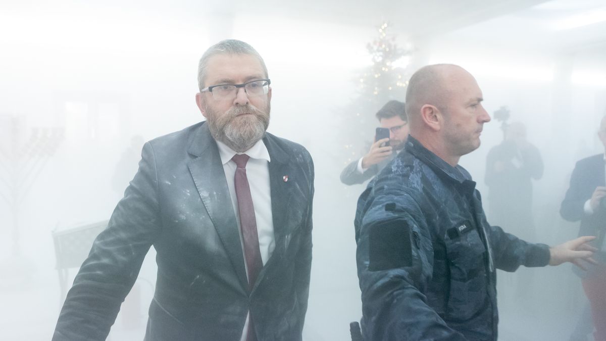 Grzegorz Braun, a far-right Polish lawmaker, is using a fire extinguisher on Hanukkah candles in parliament in Warsaw, Poland, on December 12, 2023. (Photo by Foto Olimpik/NurPhoto via Getty Images)