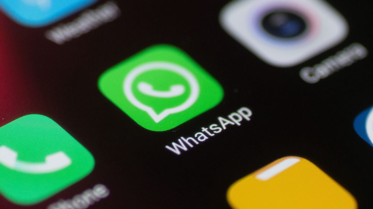 WhatsApp logo displayed on a phone screen, smartphone and keyboard are seen in this multiple exposure illustration. WhatsApp Messenger is a multiplatform mobile application that provides an encrypted instant messaging system belonging to Facebook, photo taken in Amsterdam, Netherlands on January 28, 2020 (Photo illustration by Nicolas Economou/NurPhoto via Getty Images)