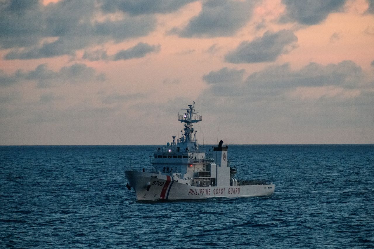 WEST PHILIPPINE SEA, PHILIPPINES - DECEMBER 10: A Philippine Coast Guard vessel escorting a ship on a resupply mission to the communities and Filipino military personnel stationed in the Spratlys, on December 10, 2023, in Palawan, Philippines. Escorted by Philippine Coast Guard ships, civil society and fishing community gathered in El Nido town to embark on a civilian-led resupply and gift mission to residents and military personnel stationed in the far flung islands in the contested area of the Spratlys group of islands as Christmas nears. The mission was cut short as China navy and coast guard ships present in the area prompted the captain of the Filipino supply boat to turn back, against the assurance of the Philippine Coast Guard to push through. China cost guard ships earlier fired water cannons and rammed another civilian boat performing resupply missions to Ayungin Shoal and a government fisheries boat in Scarborough shoal. The Philippines, the only predominantly Christian nation in South East Asia, has been celebrating Christmas for more than 400 years. (Photo by Jes Aznar/Getty Images)