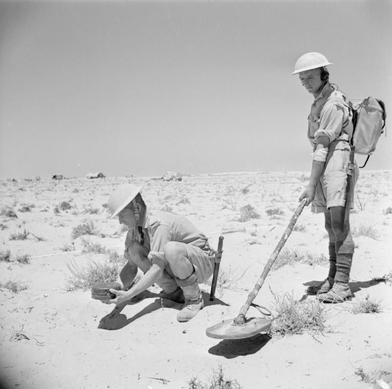 Soldiers with a mine detector