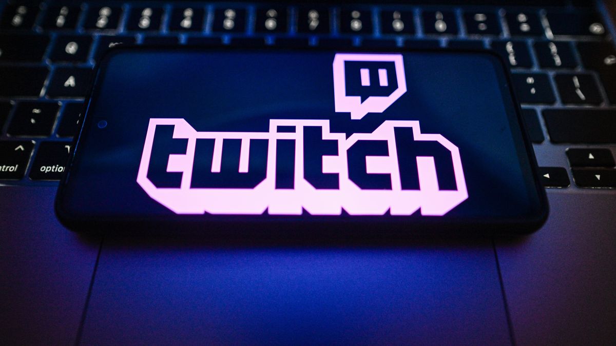 POLAND - 2026/05/14: In this photo illustration, a Twitch logo is seen displayed on a smartphone on the top of a laptop. (Photo Illustration by Omar Marques/SOPA Images/LightRocket via Getty Images)
