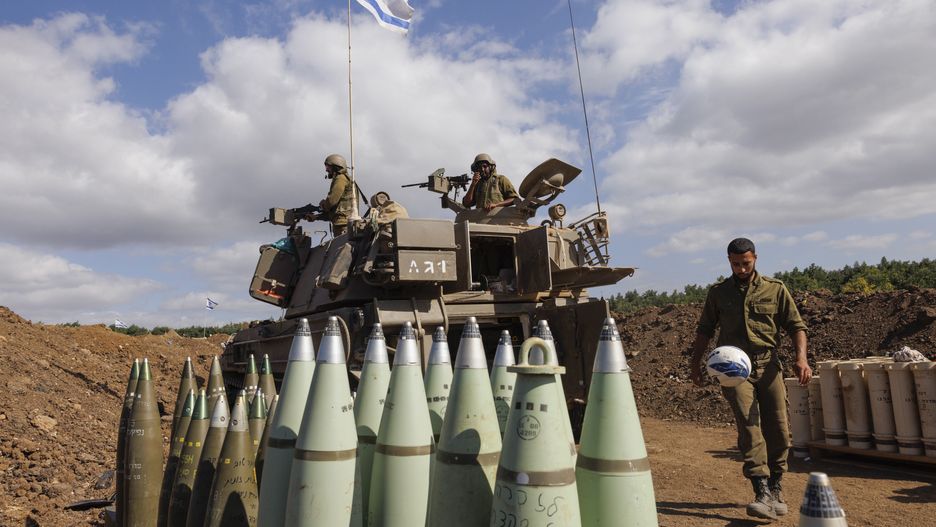 A soldier plays with a football beside an armored vehicle at an army artillery base near the border with Lebanon in northern Israel, on Friday, Nov. 10, 2023. A concern for Israel's military and the country is Hezbollah, which has nearly 10 times the number of missiles as Hamas and a bigger, more professional fighting force. Photographer: Kobi Wolf/Bloomberg via Getty Images