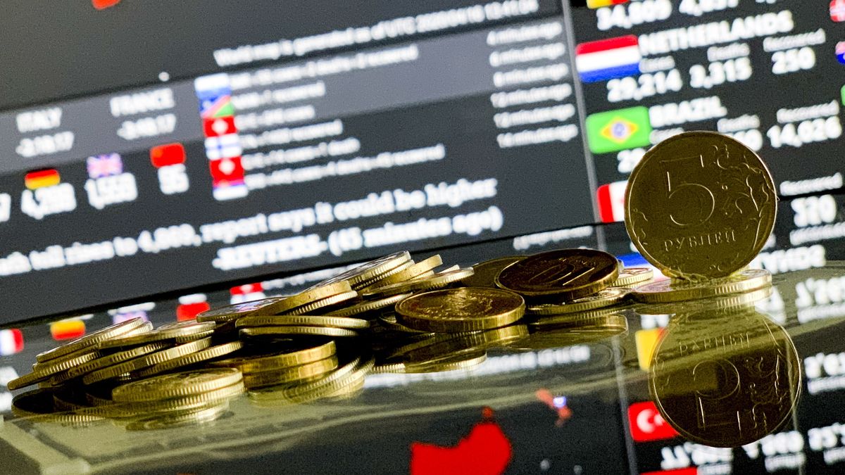 MOSCOW, RUSSIA - APRIL 16: Russian ruble coins are seen with Coronavirus Pandemic COVID - 19 Live World Map / Count board in Moscow, Russia on April 16, 2020. The Russian economy has been rocked by the coronavirus outbreak, and the breakdown of the OPEC+ oil production pact between Russia and Saudi Arabia. The turmoil has shocked traders around the world and resulted in sharp volatility on the Russian stock markets and swings in the value of the ruble. (Photo by Sefa Karacan/Anadolu Agency via Getty Images)