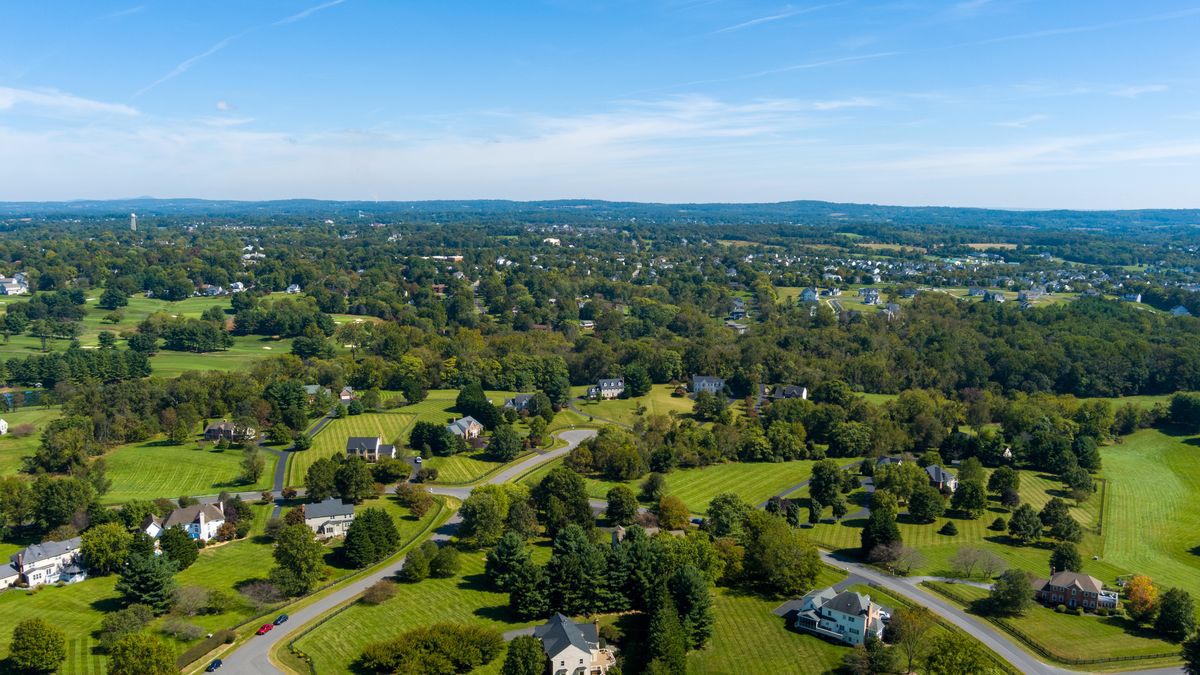 Aerial view of the Farmington on the Green subdivision in Purcellville, Loudoun County, Virginia.
autumn, single family, housing, trees, housing market, residential, house, golf course, upper middle class, clouds, home, no people, suburbia, cul-de-sac, building, home development, development, luxury, leisure, living, above, architecture, purcellville, sky, houses, clouds, suburb, drone, virginia, fall, loudoun county, modern, property, residence, landscape, real estate, high, daytime, aerial view, usa, overhead, aerial, american dream, neighborhood, road, community, subdivision, autumn, single family, housing, trees, housing market, residential, house, golf course, upper middle class, clouds, home, no people, suburbia, cul-de-sac, building, home development, development, luxury, leisure, living, above, architecture, purcellville, sky, houses, suburb, drone, virginia, fall, loudoun county, modern, property, residence, landscape, real estate, high, daytime, aerial view, usa, overhead, aerial, american dream, neighborhood, road, community, subdivision