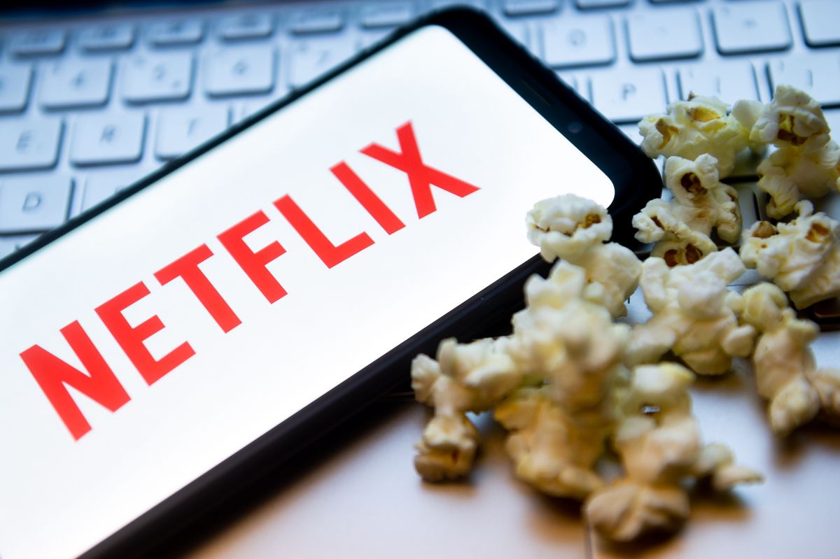 POLAND - 2022/02/03: In this photo illustration a Netflix logo seen displayed on a smartphone with popcorns and laptop keyboard in the background. (Photo Illustration by Mateusz Slodkowski/SOPA Images/LightRocket via Getty Images)