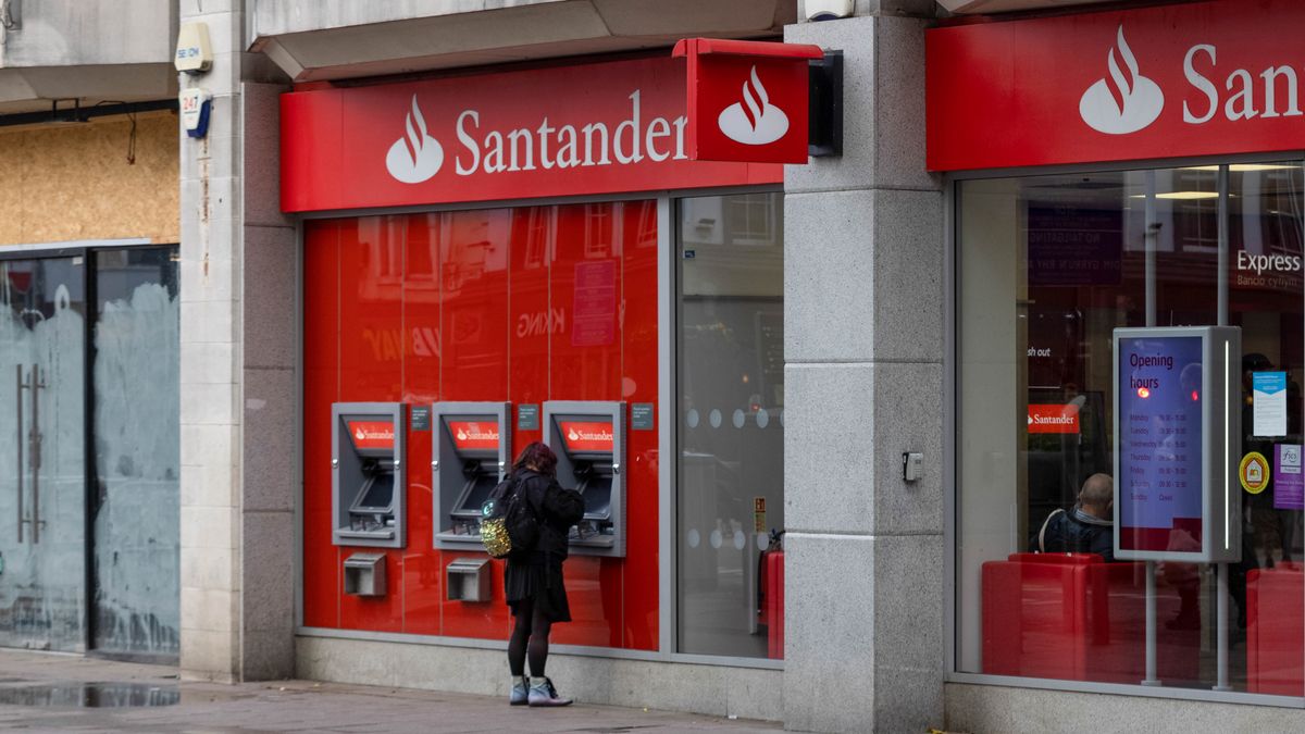 A woman uses an automated teller machine at a bank branch of Banco Santander SA on Queen Street in Cardiff, UK, on Friday, Oct. 28, 2022. UK inflation could soar to 15% or more early next year unless the government sets out further measures to protect households from a jump in energy bills, economists said. Photographer: Hollie Adams/Bloomberg via Getty Images