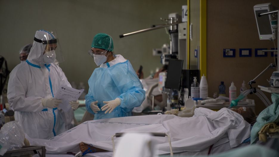 ROME, ITALY - DECEMBER 17: Health workers wearing the personal protective equipment (PPE) treat Covid-19 patient in the Intensive Care Unit (ICU) at the Covid Emergency department of the Umberto I Hospital, during the Coronavirus pandemic on December 17, 2020, in Rome, Italy. There have been over 1,870,000 reported coronavirus (COVID-19) cases in Italy and more than 65,857 related deaths since the beginning of the pandemic. (Photo by Antonio Masiello/Getty Images)