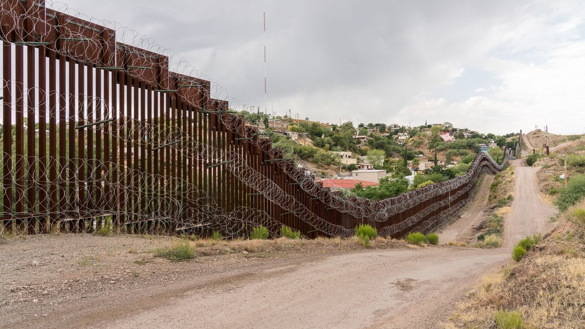 The US/Mexico border fence in Nogales, Arizona USA
High steel wall with concertina wire, and the dirt road along where the border patrol truck drive on.
Yuko Smith photography
nogales