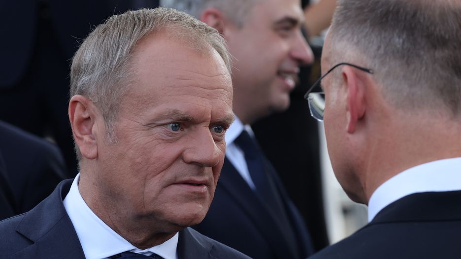 Polish Prime Minister Donald Tusk and Polosh Prime Minister Andrzej Duda during Armed Forces Day parade in Warsaw, Poland on August 15, 2024. (Photo by Jakub Porzycki/NurPhoto via Getty Images)