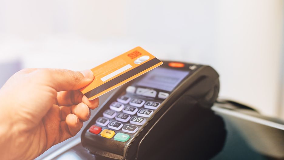 Man paying with card in a payment terminal