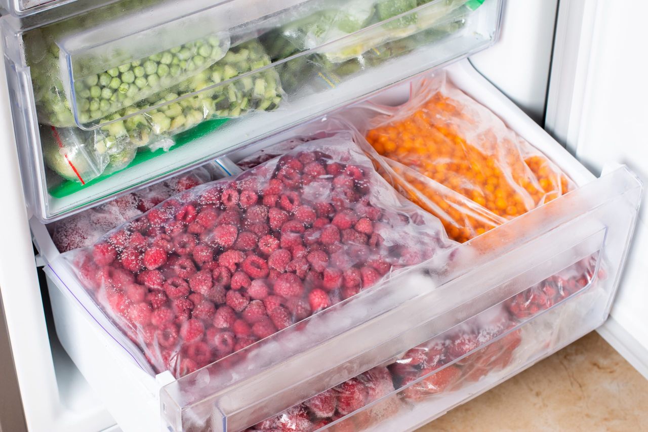 Frozen raspberries in the freezer. Frozen berries. Food storage
