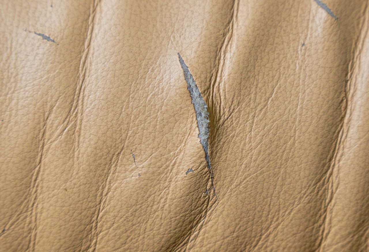 Cut, damage to the leather surface of a chair or sofa.