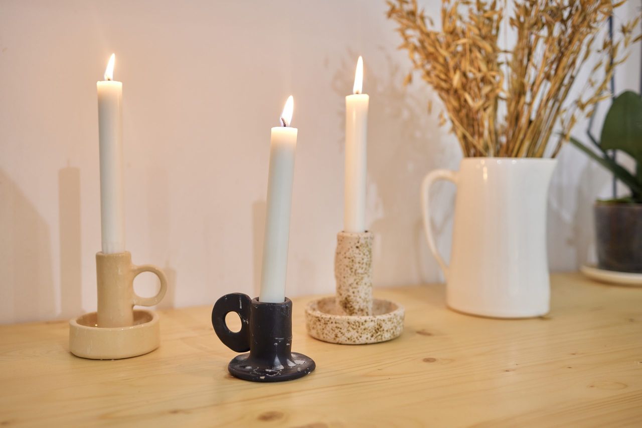 Three candles on the small table covered