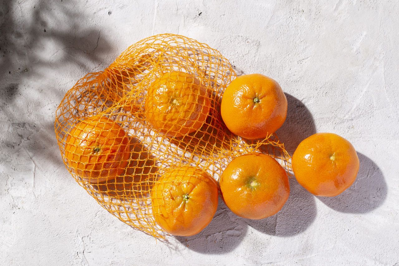 pile of fresh tangerines on the concrete table, top view