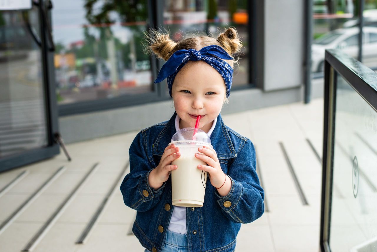 photo of cute little girl with milk cocktail