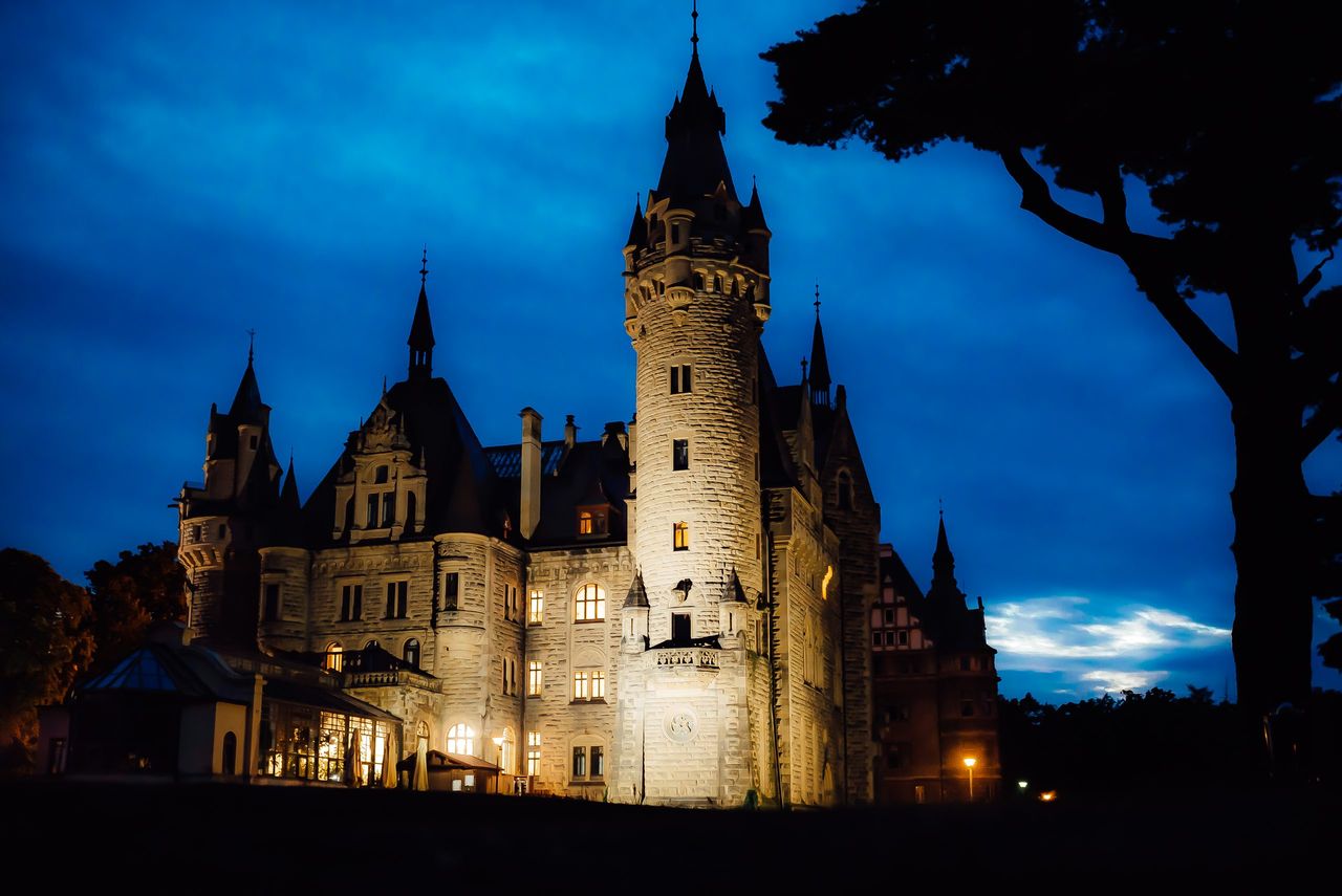 old Polish castle in the village of moszna in the night lights