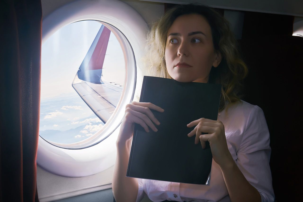 young woman being an airplane passenger experiences aerophobia