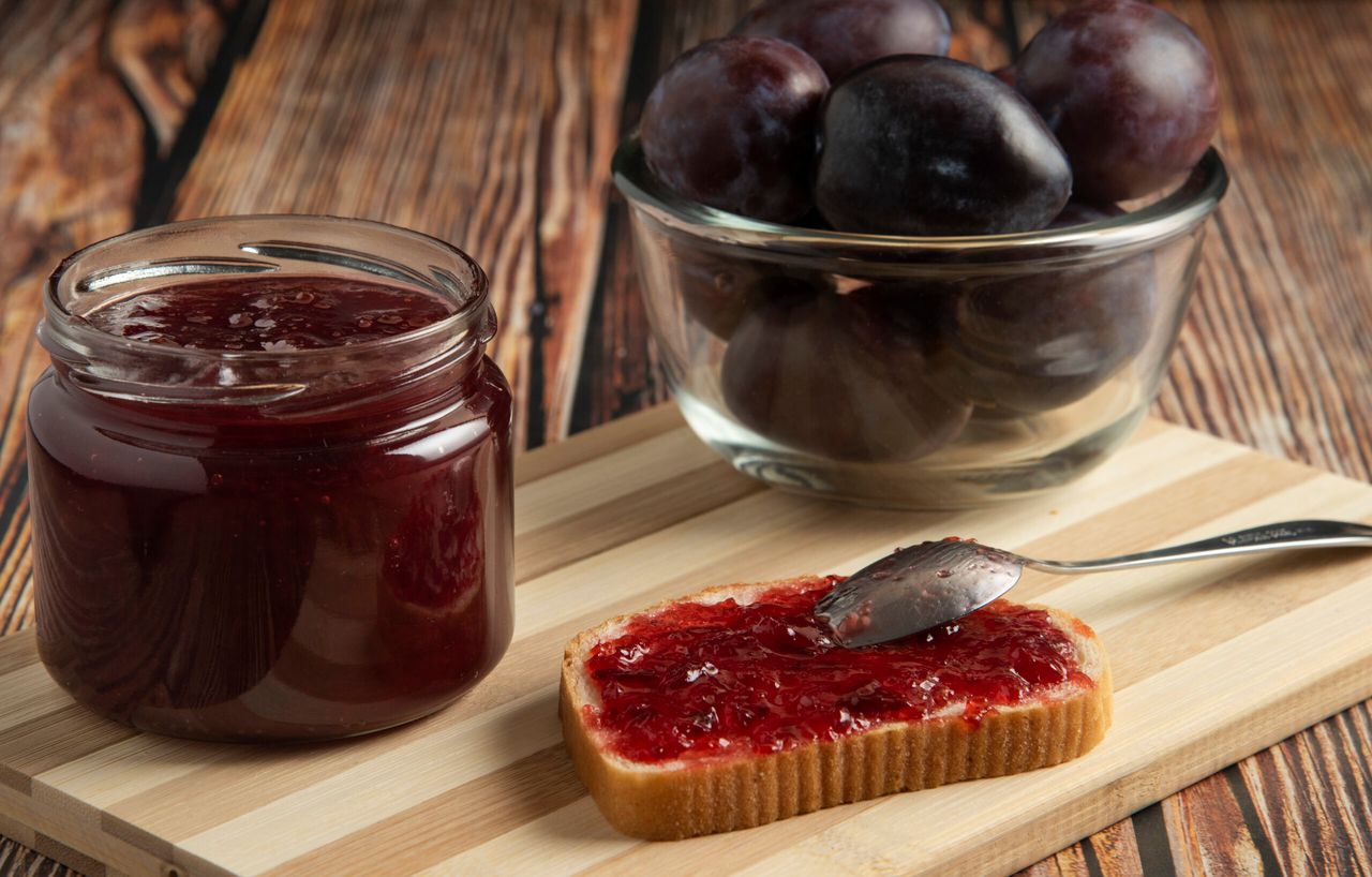 Plums with a jar of confiture and a toast bread. High quality photo