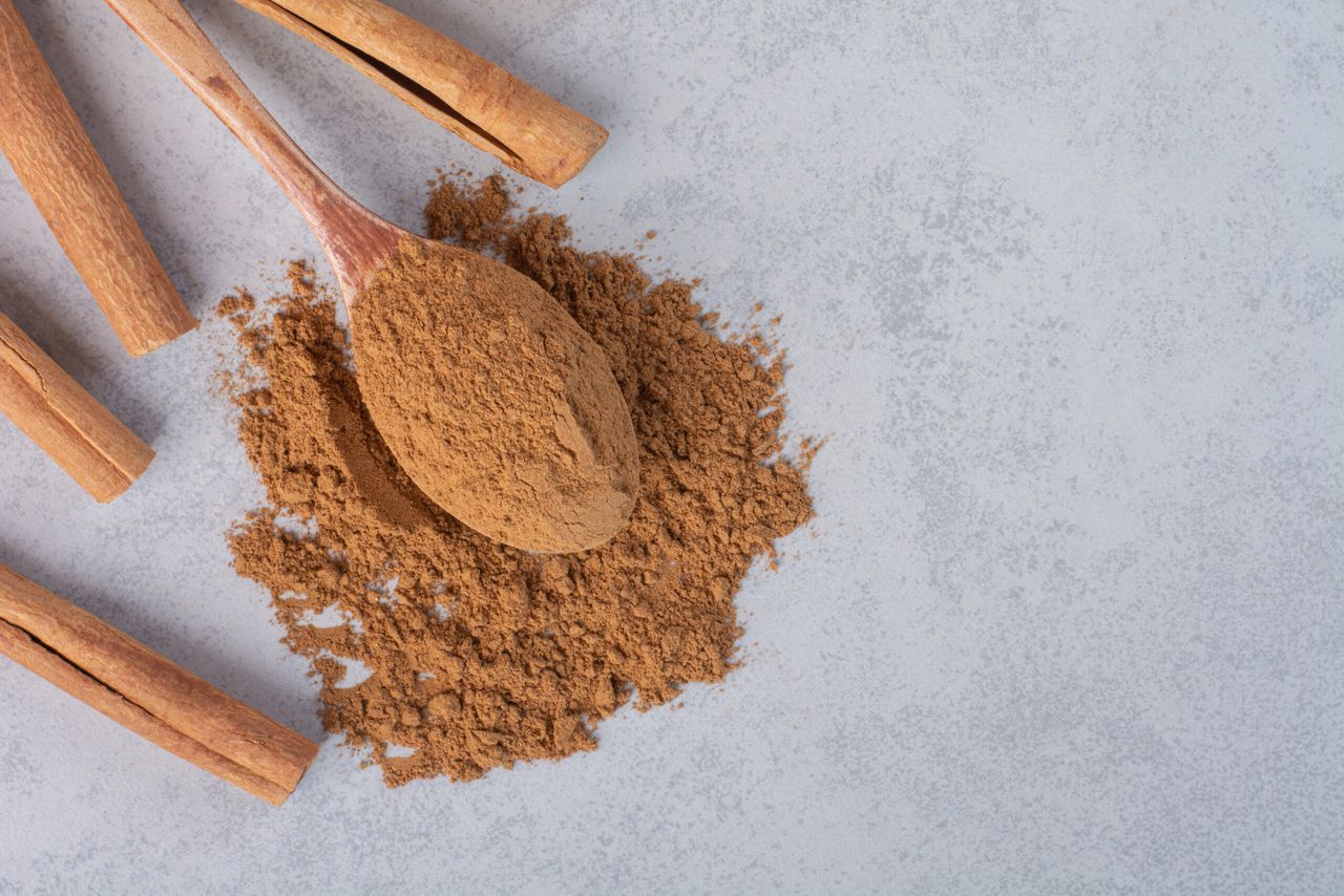 Cinnamon sticks and blended powder in a wooden spoon. High quality photo