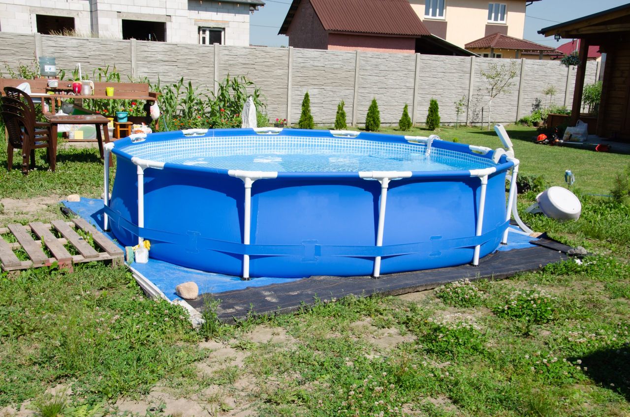 mobile pool in the backyard, round outdoor pool for the whole family on the lawn in summer,