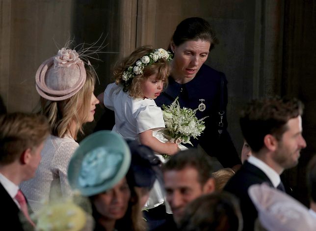 WINDSOR, UNITED KINGDOM - MAY 19: A crying flower girl is comforted inside the entrance to the chapel before the wedding of Prince Harry to Meghan Markle in St George's Chapel at Windsor Castle on May 19, 2018 in Windsor, England. (Photo by Owen Humphreys - WPA Pool/Getty Images) 