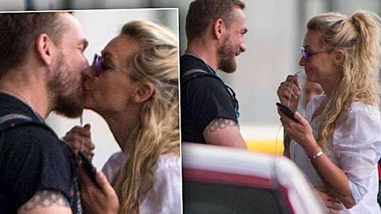 Martyna Wojciechowska i Przemysław Kossakowski całują się na lotnisku